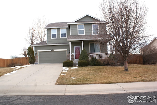 view of front of house with a front yard, covered porch, and a garage