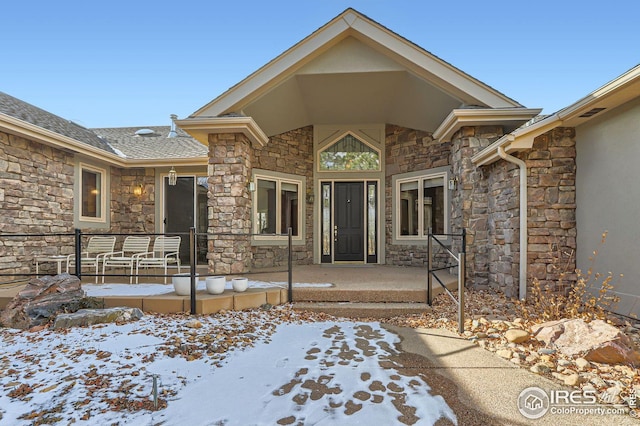 view of snow covered property entrance