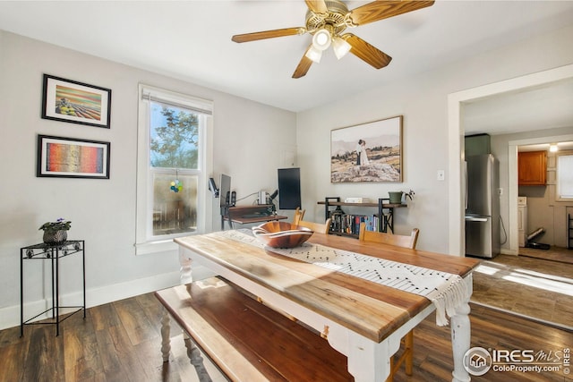 dining area with ceiling fan and dark hardwood / wood-style flooring