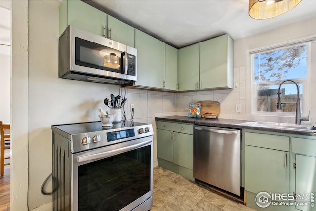 kitchen featuring sink, appliances with stainless steel finishes, and green cabinets