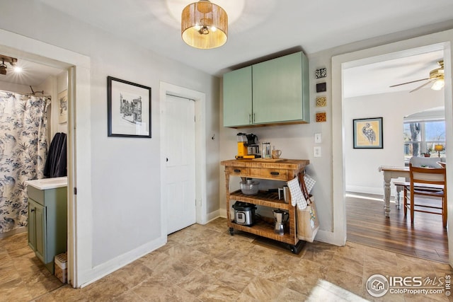 kitchen featuring green cabinets and ceiling fan