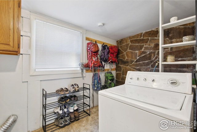 laundry room featuring cabinets and washer / clothes dryer