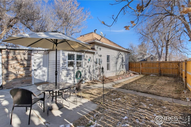 back of property with a patio