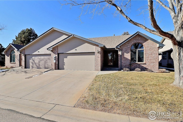 ranch-style house with a garage and a front lawn