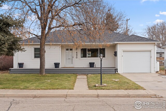 ranch-style home with a garage and a front lawn