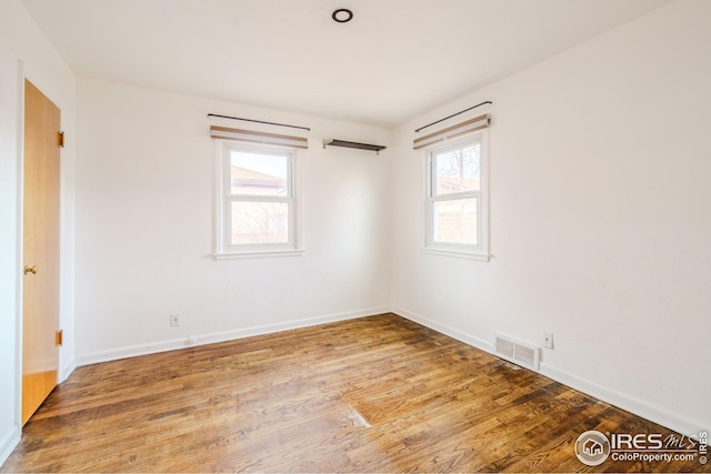 empty room with hardwood / wood-style floors