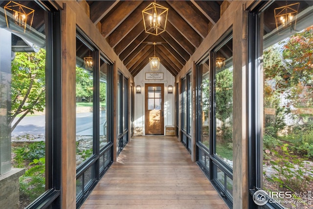 unfurnished sunroom with lofted ceiling and a healthy amount of sunlight