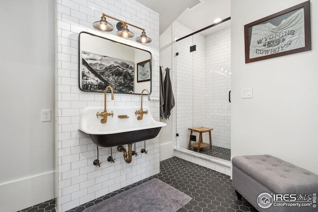 bathroom featuring a stall shower, tile patterned flooring, and tile walls