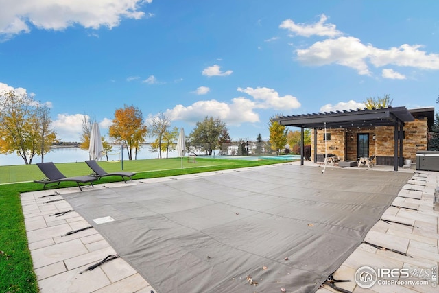 exterior space featuring a patio area, a yard, a water view, and a pergola