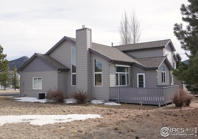 back of property with a wooden deck