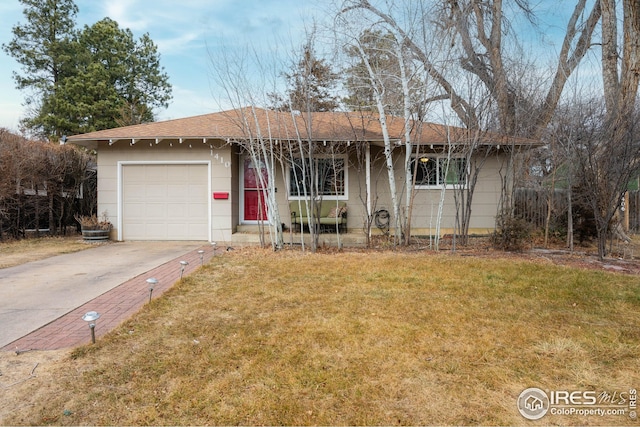 ranch-style house featuring a garage and a front lawn