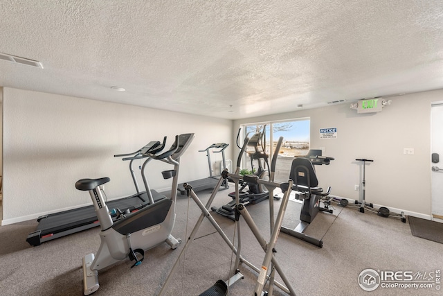 exercise room featuring a textured ceiling