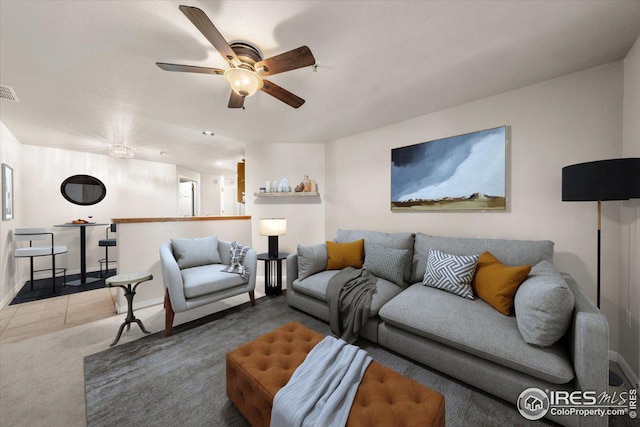 living room featuring ceiling fan and carpet