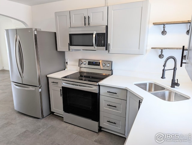 kitchen featuring sink, gray cabinetry, and stainless steel appliances