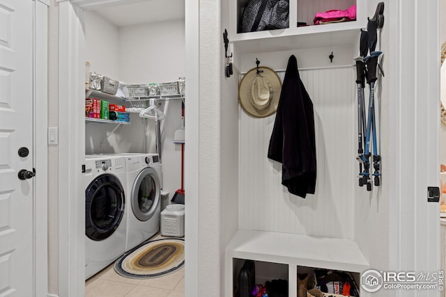 laundry area with light tile patterned flooring and independent washer and dryer