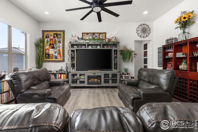 living room featuring hardwood / wood-style flooring and ceiling fan