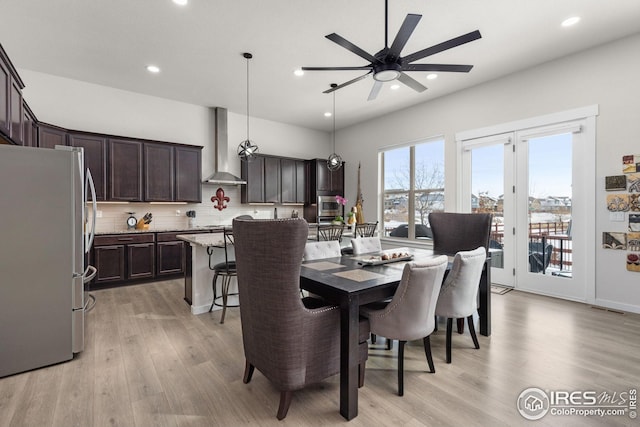 dining space featuring ceiling fan and light hardwood / wood-style flooring