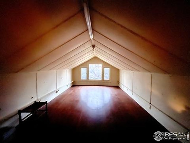 bonus room with vaulted ceiling with beams