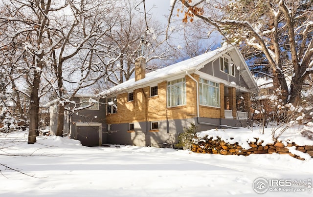 exterior space with a garage and a chimney