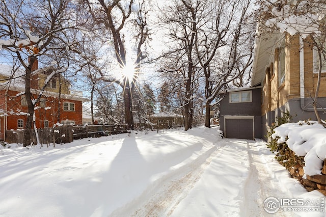 yard layered in snow featuring a garage