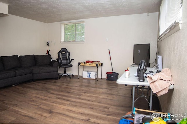 office with a textured ceiling and dark hardwood / wood-style flooring