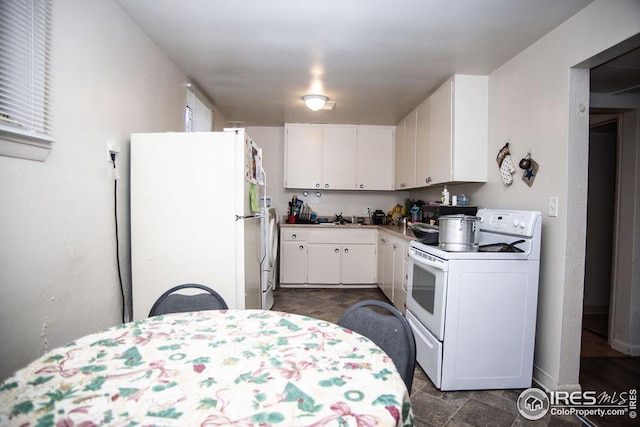 kitchen with sink, white appliances, and white cabinets