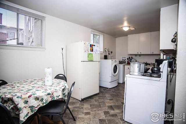 kitchen with white fridge and white cabinetry