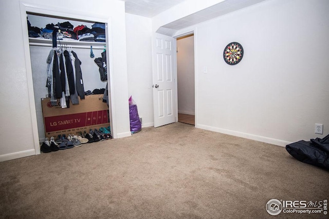 carpeted bedroom featuring a closet