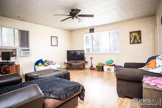 living room with ceiling fan, a healthy amount of sunlight, and light hardwood / wood-style flooring