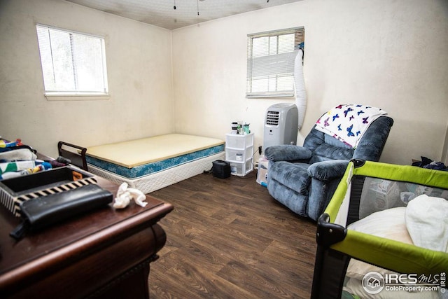 bedroom with dark hardwood / wood-style floors