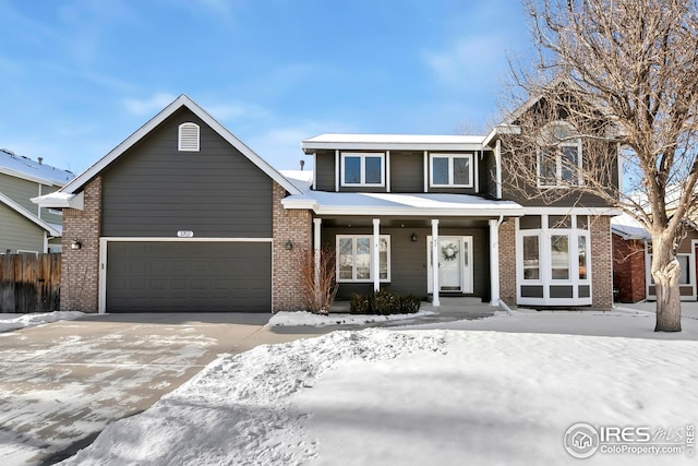 view of front property featuring a porch and a garage