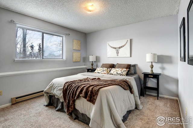 carpeted bedroom featuring baseboard heating and a textured ceiling