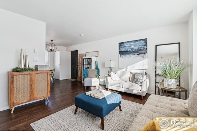 living room featuring dark hardwood / wood-style floors and a notable chandelier