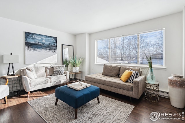 living room featuring baseboard heating, hardwood / wood-style floors, and a wealth of natural light