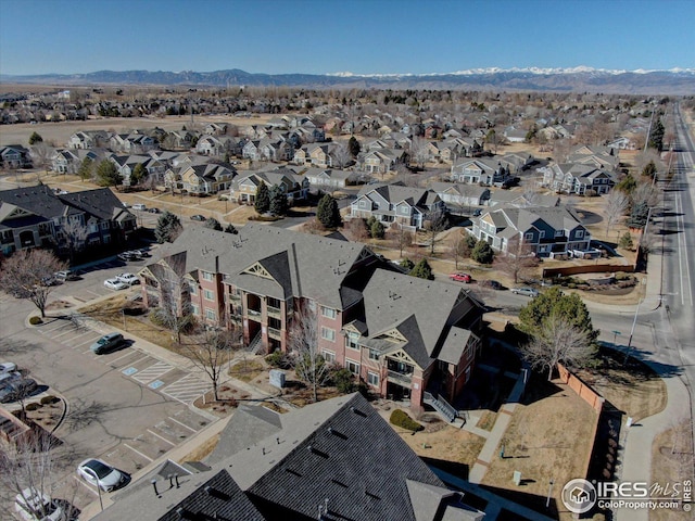 drone / aerial view featuring a residential view and a mountain view