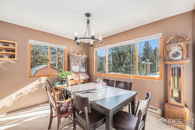 dining space featuring a notable chandelier, carpet, a wealth of natural light, and baseboard heating