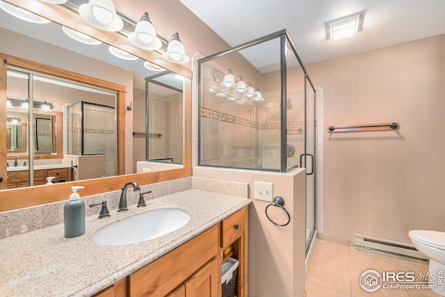 bathroom with a baseboard radiator, tile patterned floors, vanity, toilet, and walk in shower