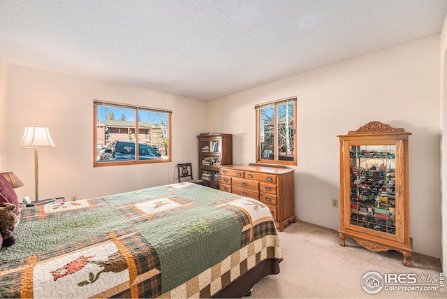 carpeted bedroom featuring a textured ceiling