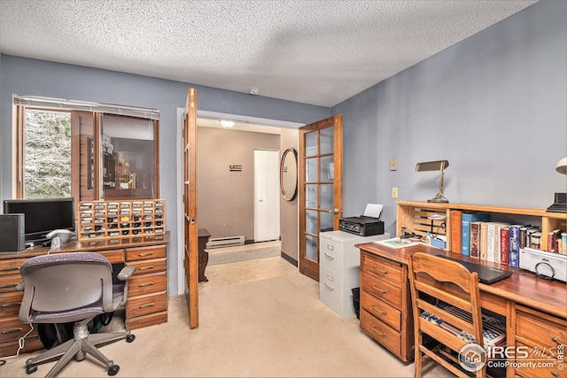 carpeted office space featuring a baseboard heating unit and a textured ceiling