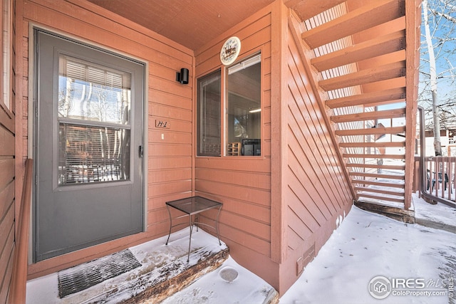 view of snow covered property entrance