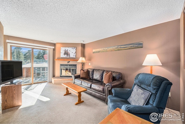 carpeted living room featuring a textured ceiling