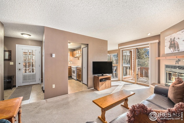 living room with a textured ceiling and light tile patterned flooring