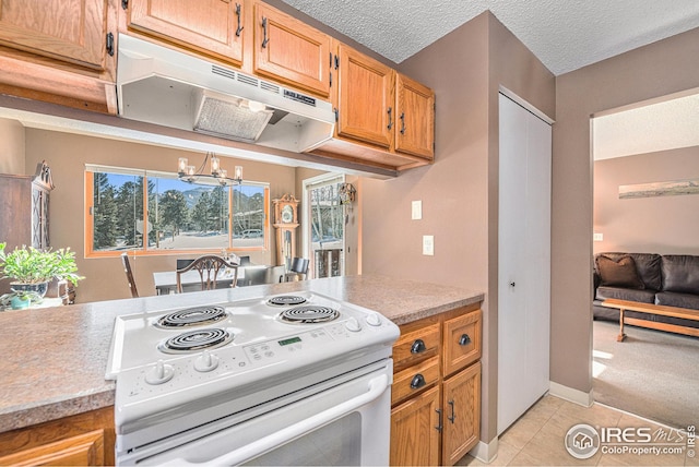 kitchen with light tile patterned flooring, a textured ceiling, a chandelier, and white range with electric cooktop