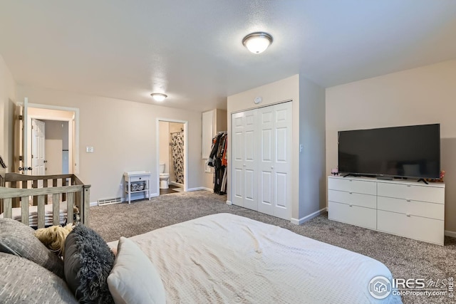 carpeted bedroom featuring connected bathroom and a closet