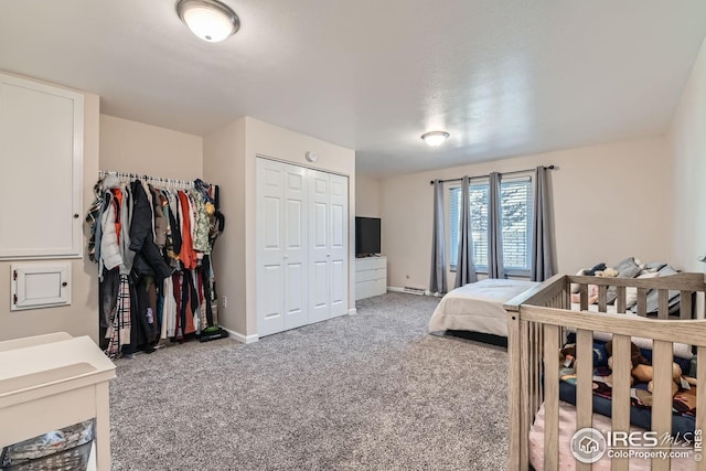 carpeted bedroom with a nursery area and a closet