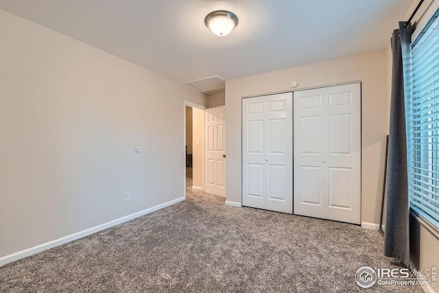 unfurnished bedroom featuring carpet floors and a closet