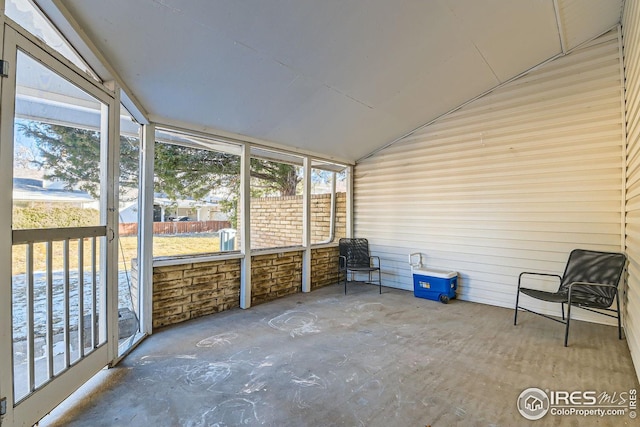 unfurnished sunroom with lofted ceiling