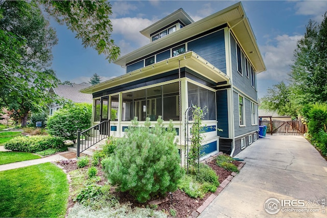 view of front of house featuring a sunroom