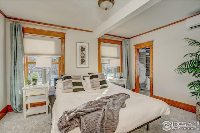 bedroom with a walk in closet, an AC wall unit, light colored carpet, and crown molding