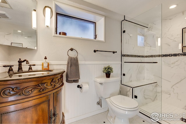 bathroom with a shower with door, toilet, tile patterned flooring, and vanity